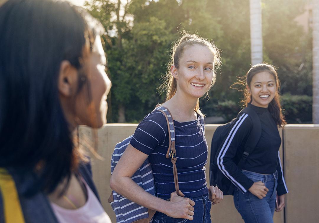 3 students walking together at St Lucia campus