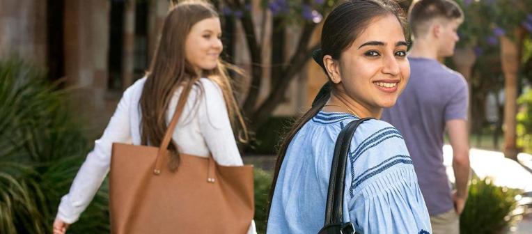 A smiling student looks back over her shoulder