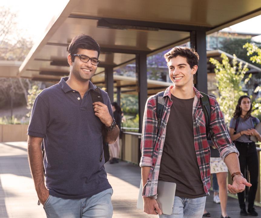 Two students on UQ walkway