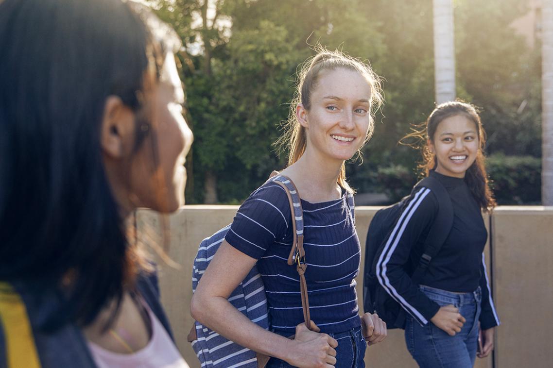 3 students walking together at St Lucia campus