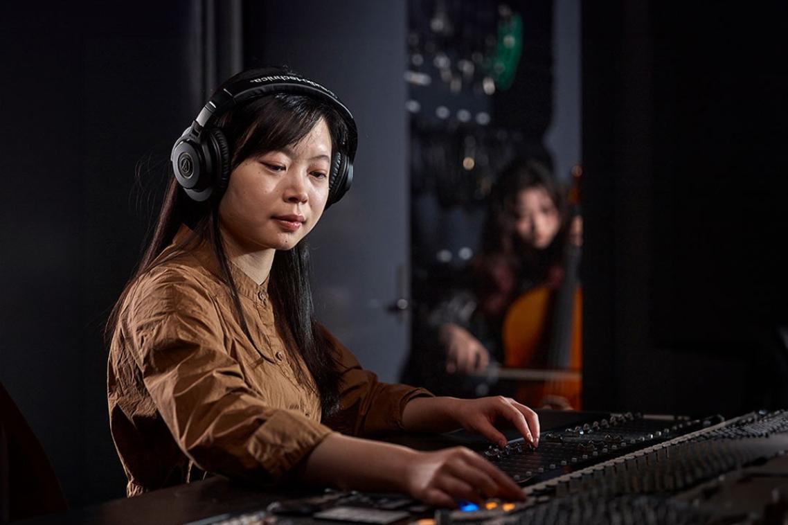 An audio engineering student in a studio